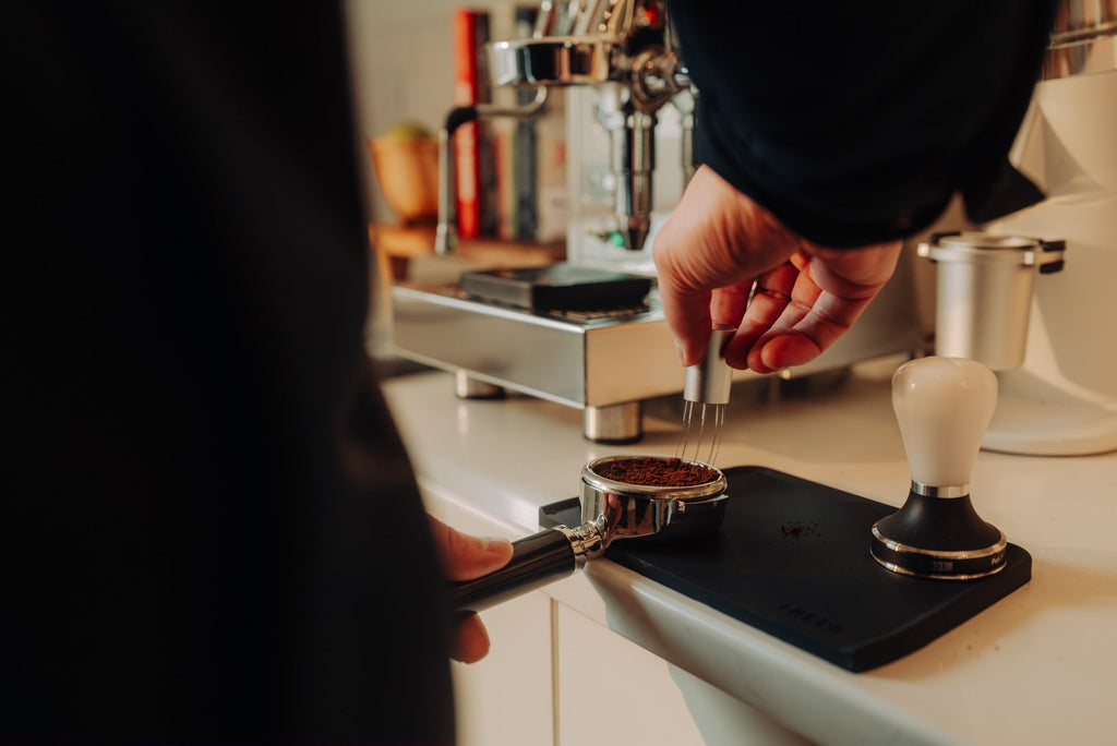 WDT tool distributing coffee in a portafilter lifestyle by clive coffee