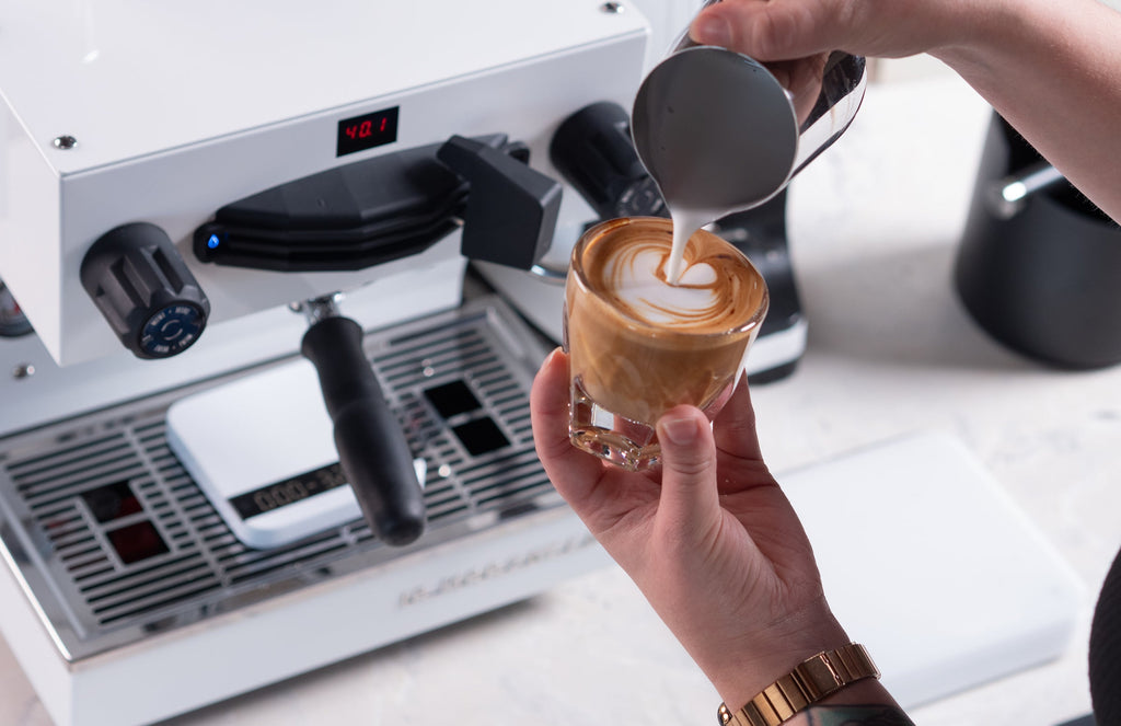 talent pouring a latte into a glass lifestyle by clive coffee