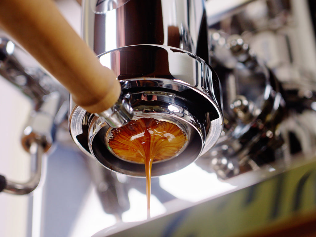 close up underside of an espresso shot exctraction lifestyle by clive coffee